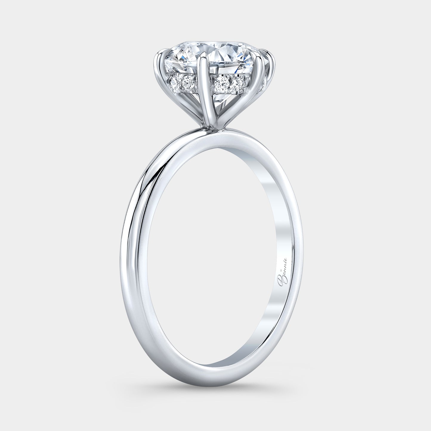 Platinum diamond ring on hand, round halo.