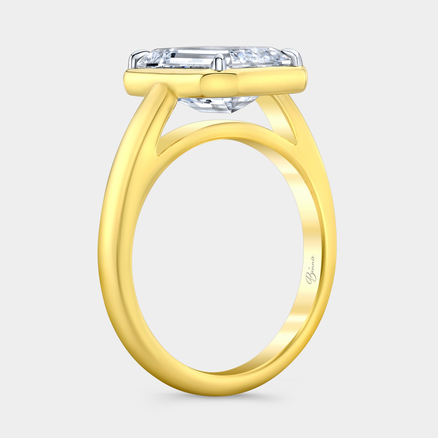 Two tone diamond ring on hand, emerald bezel.