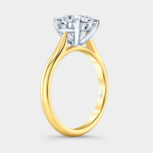 Two tone diamond ring on hand, round solitaire.
