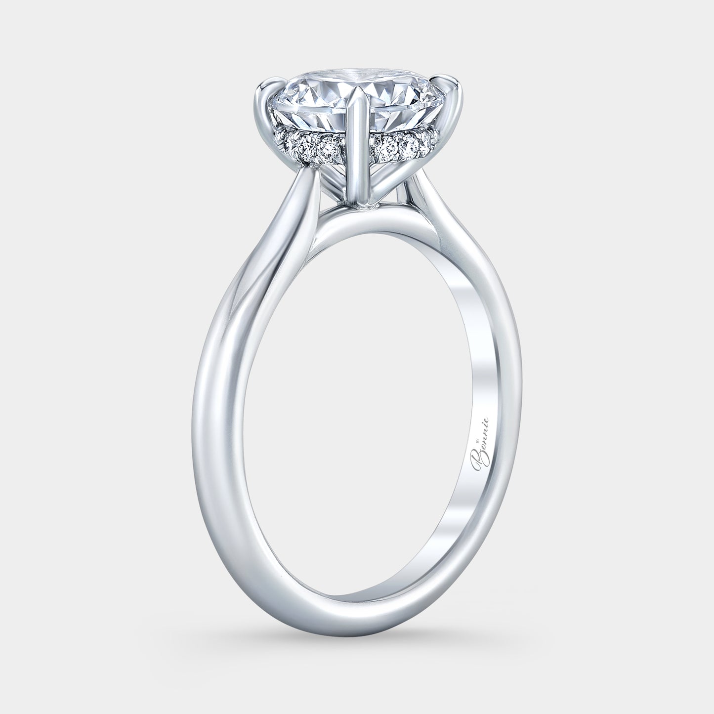Platinum diamond ring on hand, round halo.