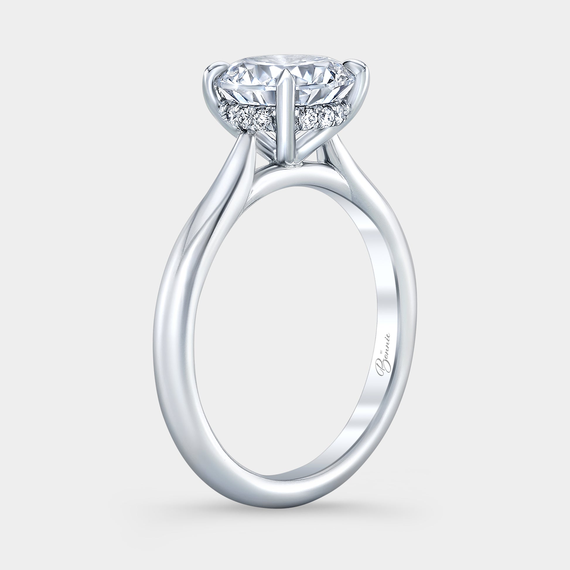Platinum diamond ring on hand, round halo.