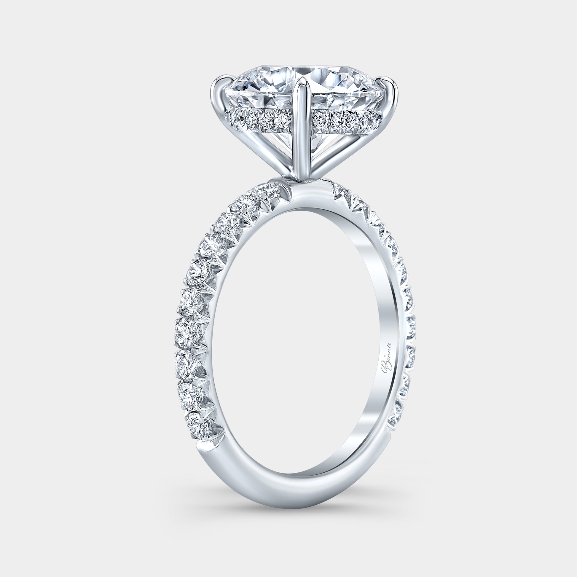 Round diamond halo ring, white gold band, French pave.