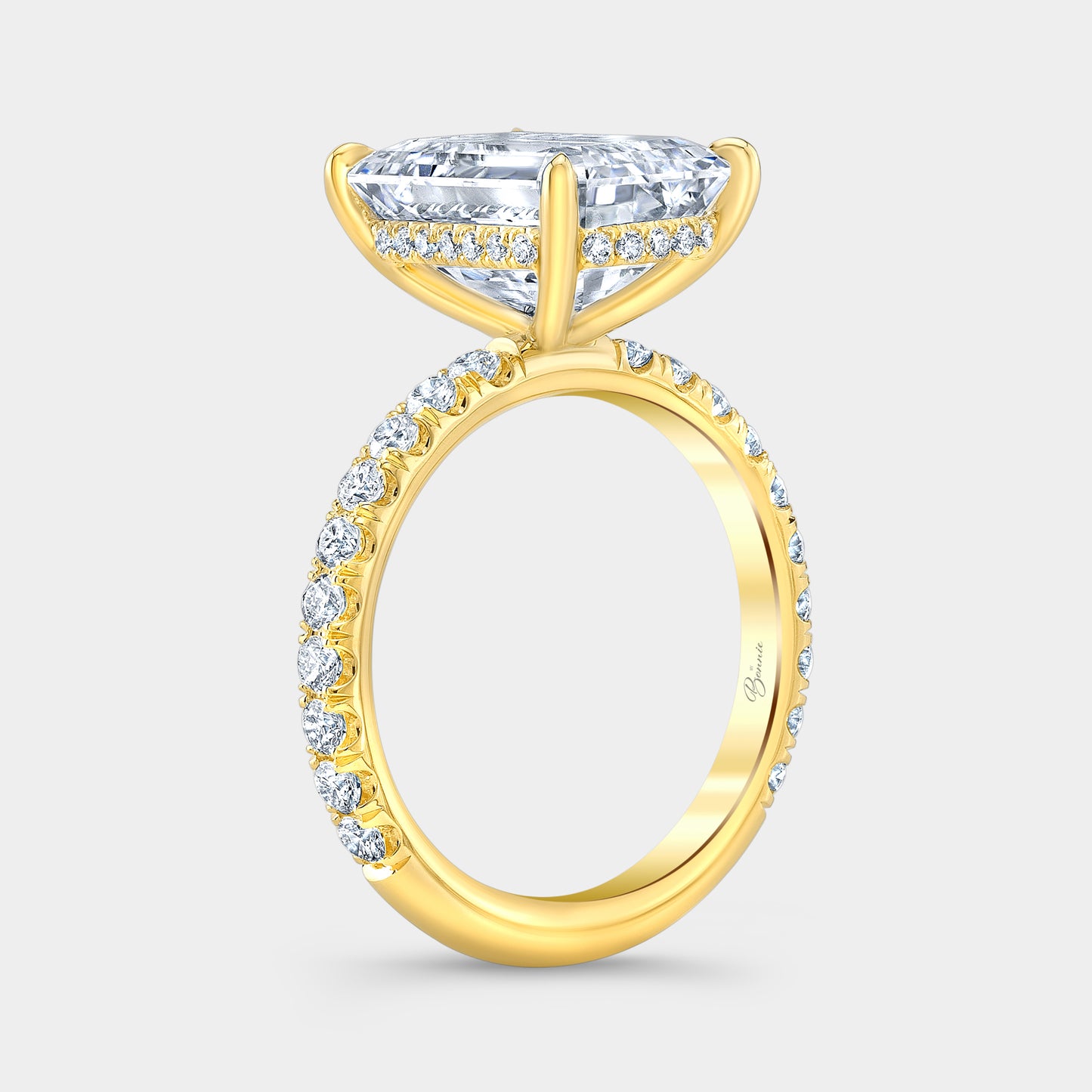 Yellow gold emerald diamond ring, 45 degree, hidden halo.