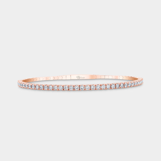 Diamond bangle worn on wrist, rose gold setting.