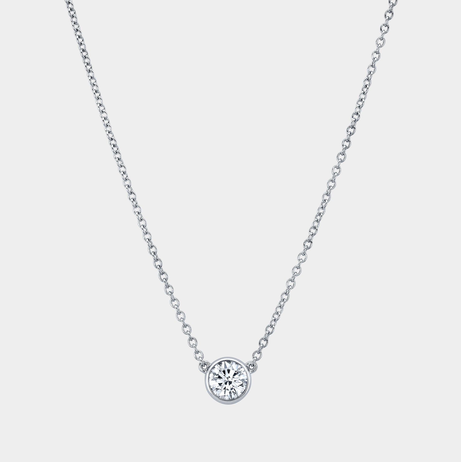 Platinum necklace, round diamond pendant, bezel setting.