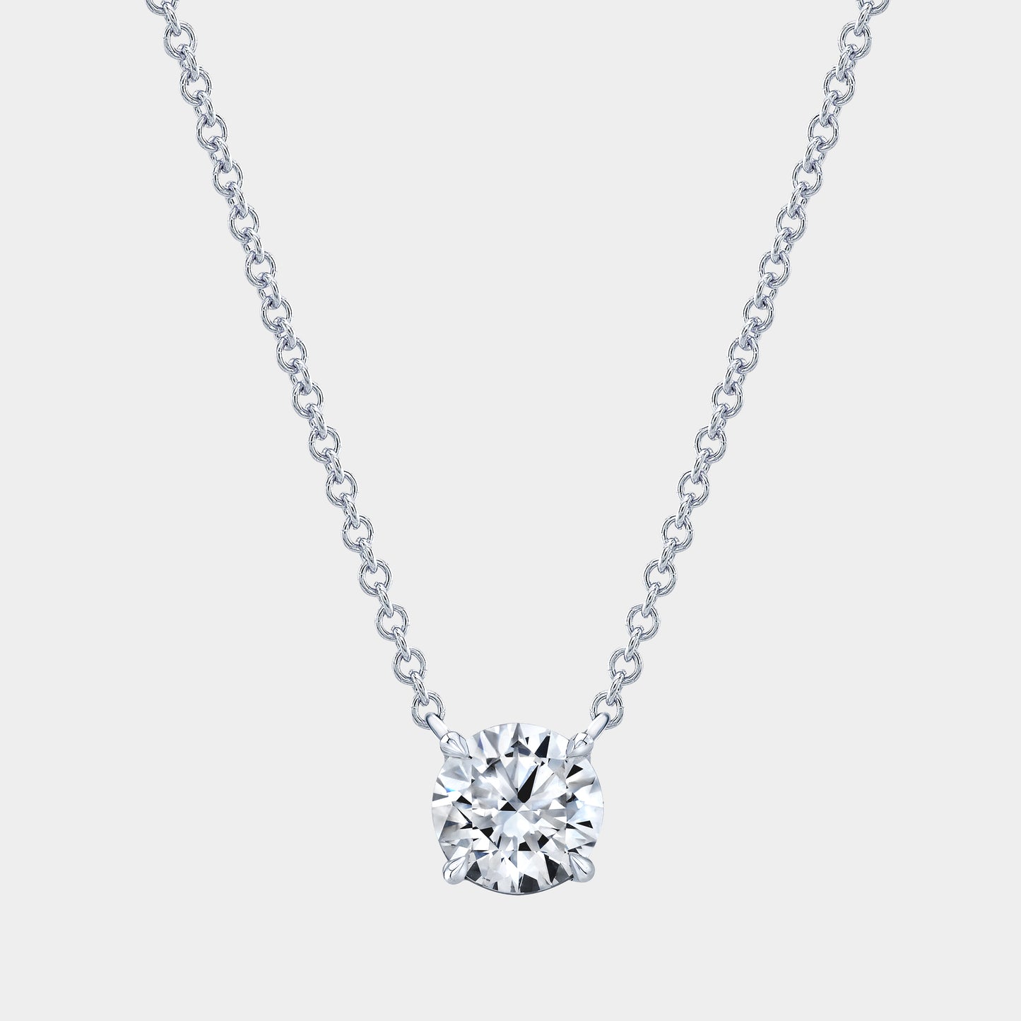 Platinum necklace, round diamond pendant, 4 prong basket setting.