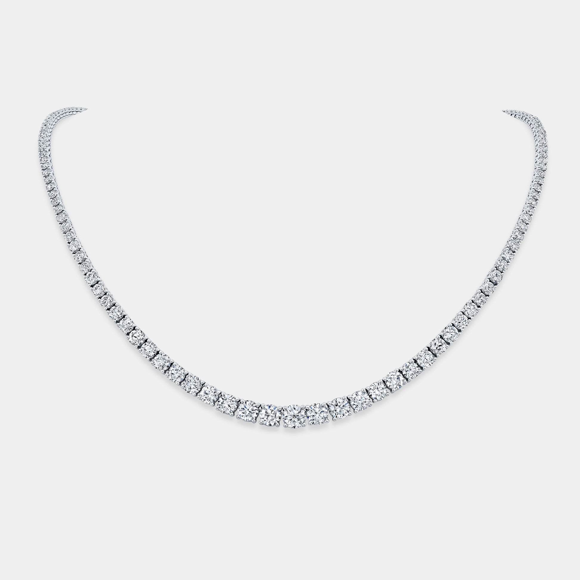 Necklace worn on person, round lab grown diamonds, graduating design.