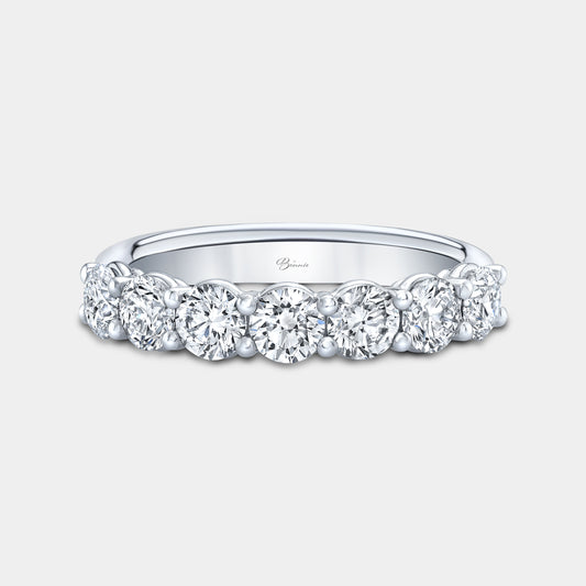 Platinum wedding band, round diamonds, shared prong setting.