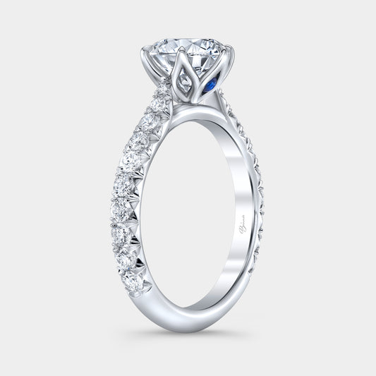 Platinum diamond ring on hand, round tulip pave.