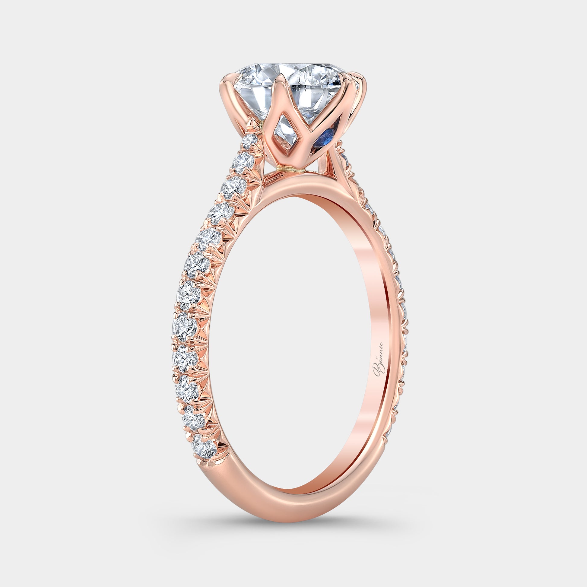 Rose gold diamond ring on hand, round tulip pave.
