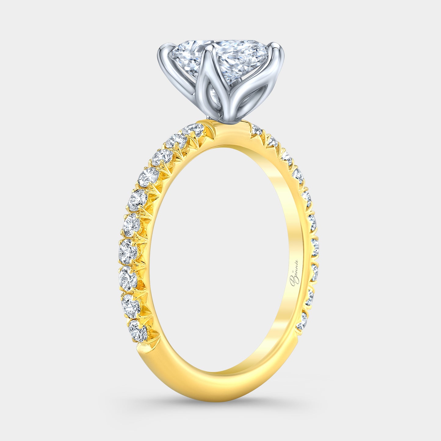 Two tone diamond ring on hand, pear tulip pave.