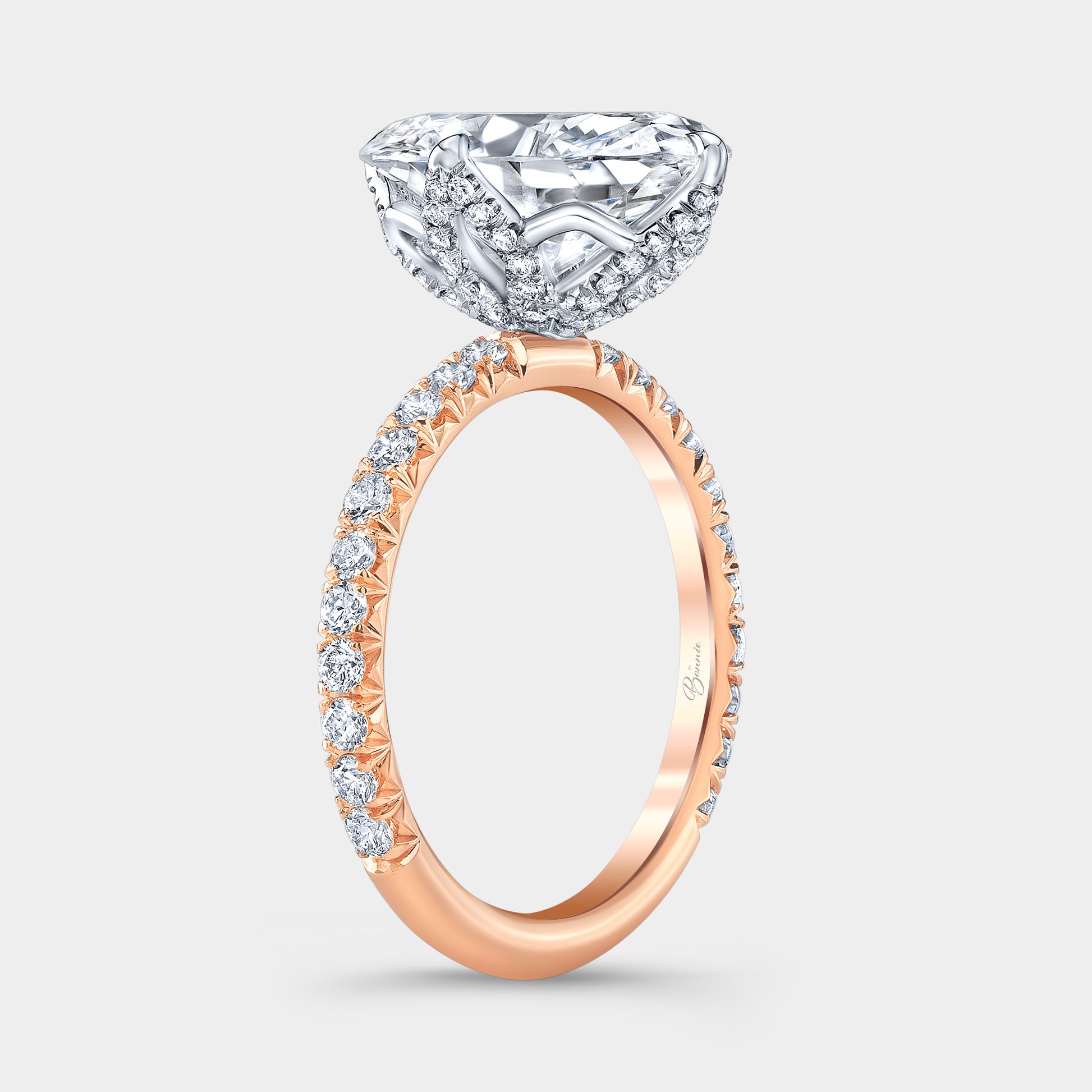 Two tone diamond ring on hand, oval tulip pave.