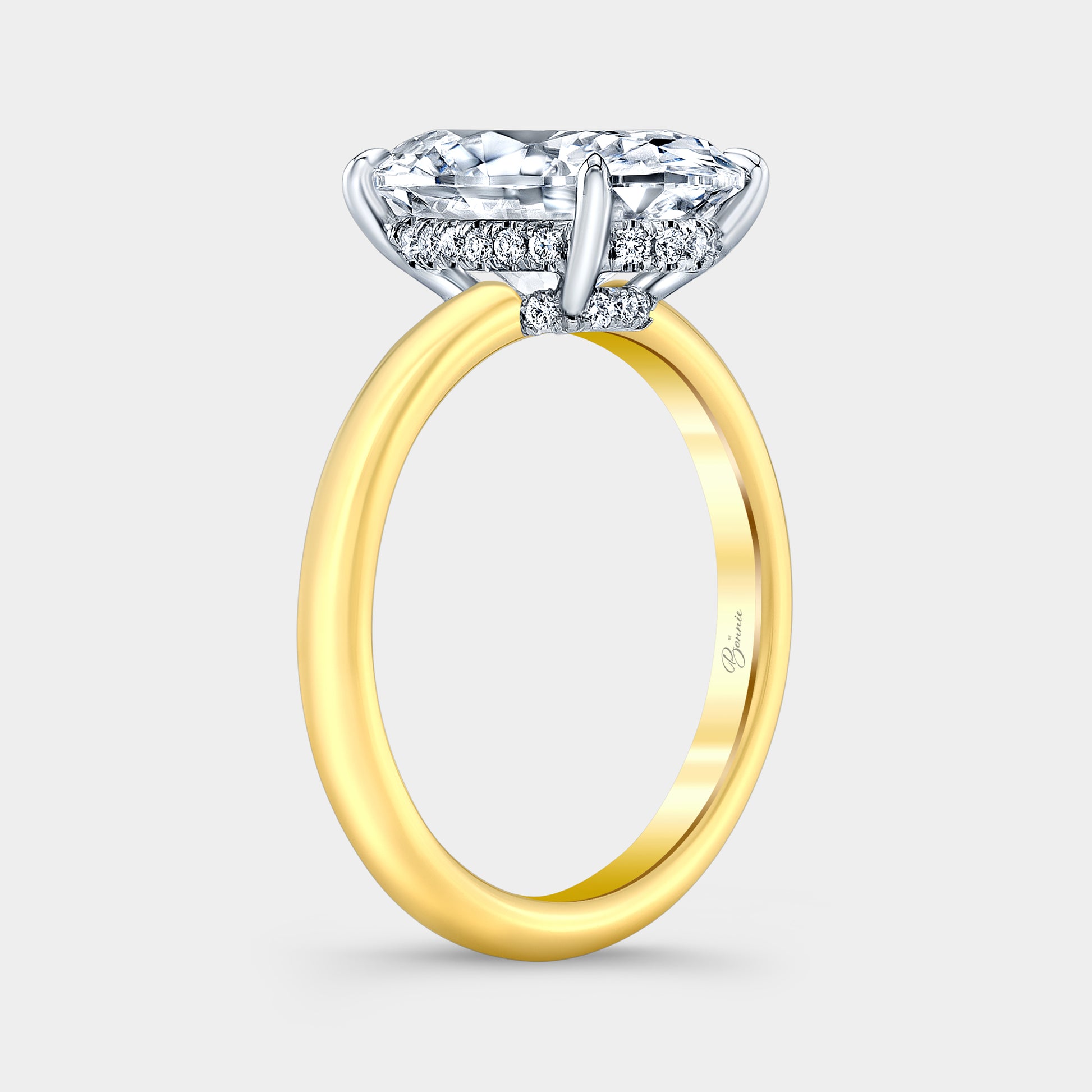 Two tone diamond ring on hand, oval halo.