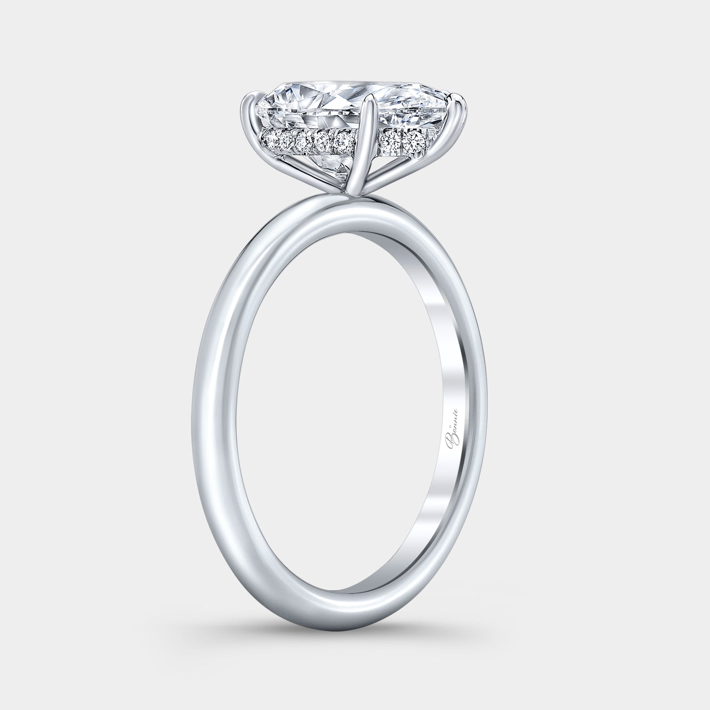 White gold diamond ring on hand, pear halo.