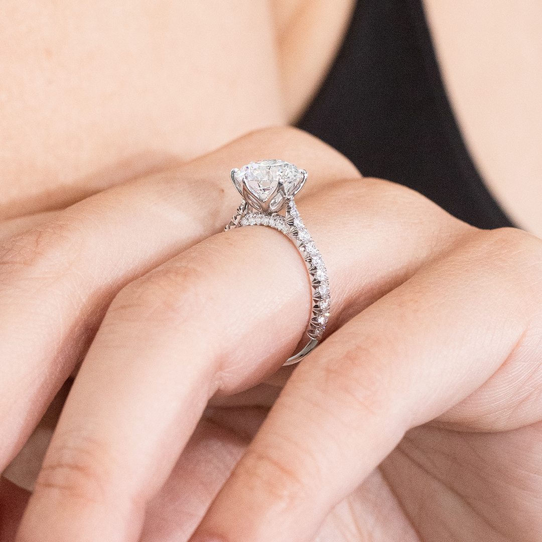 Engagement ring being worn on finger.