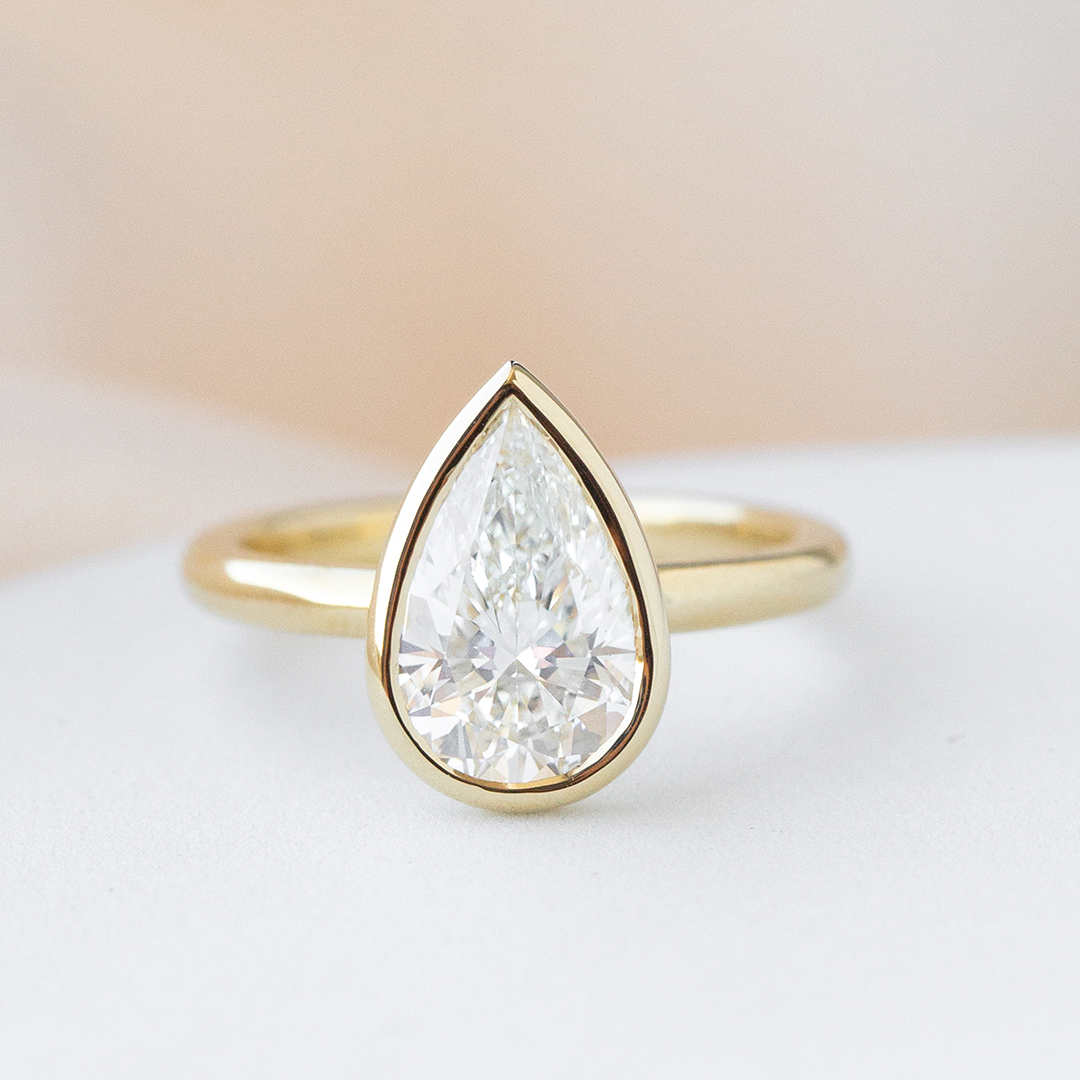 Pear ring, top down, bezel solitaire.