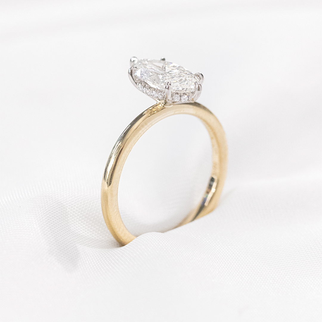 Marquise solitaire ring, yellow gold & platinum, halo.