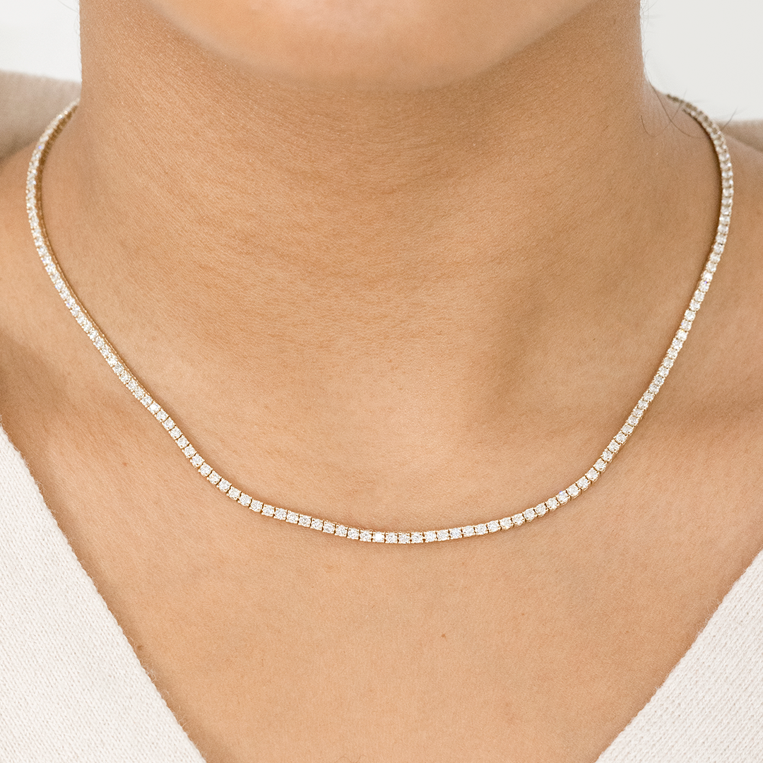 Necklace worn on person, round natural diamonds, tennis setting.