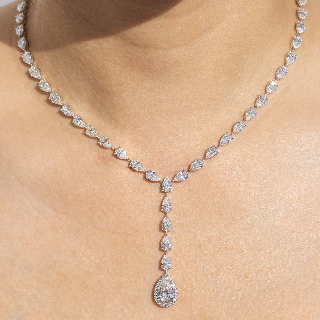 Necklace worn on person, pear diamond drop pendant.