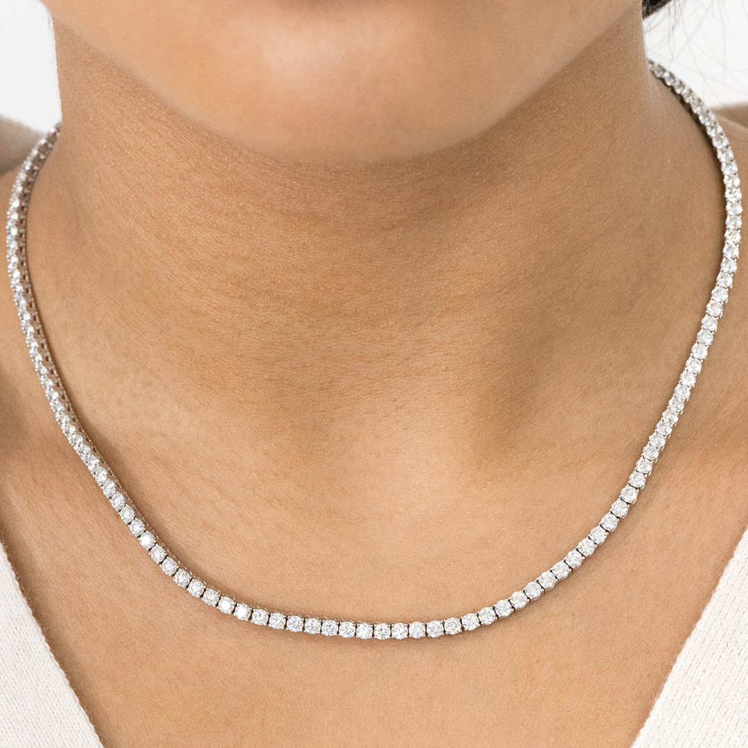 Necklace worn on person, round lab grown diamonds, tennis setting.