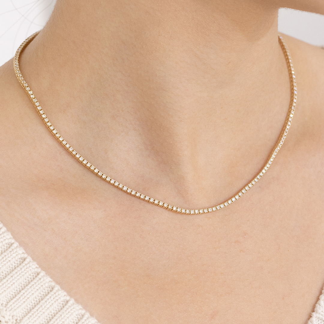 Yellow gold choker with diamond tennis line.