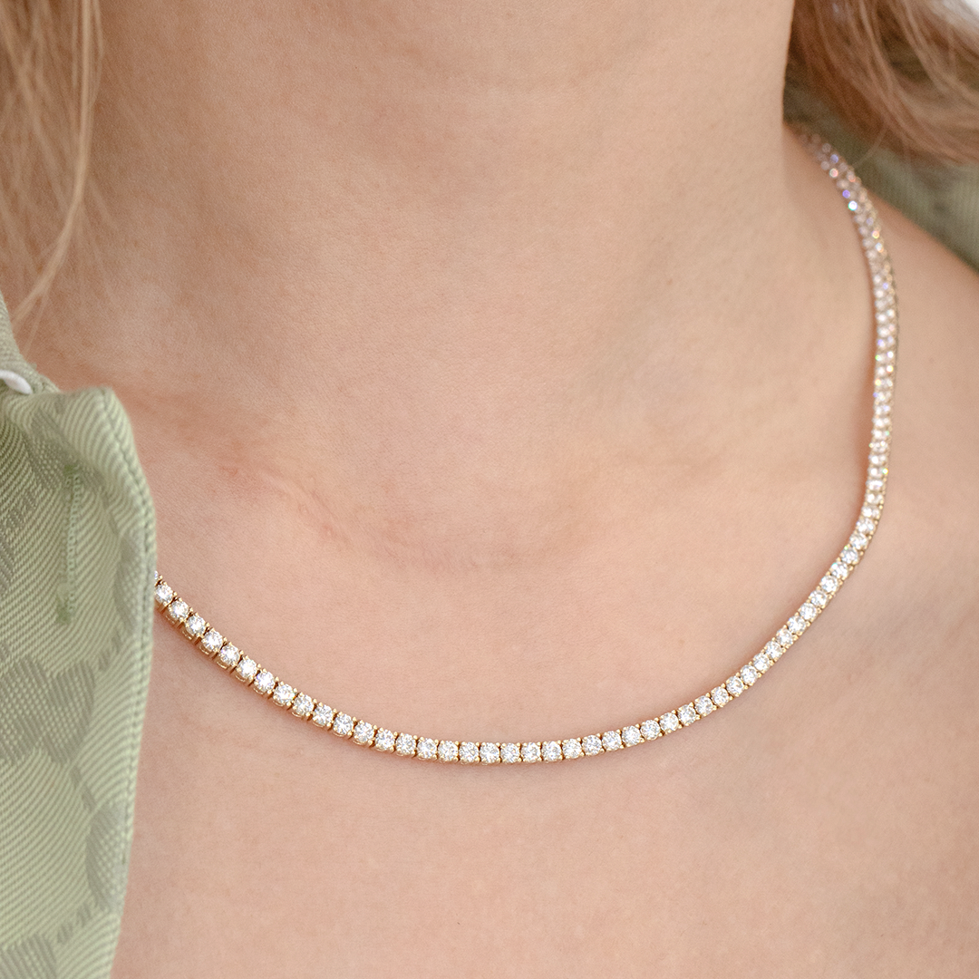 Necklace worn on person, round lab grown diamonds, tennis setting.