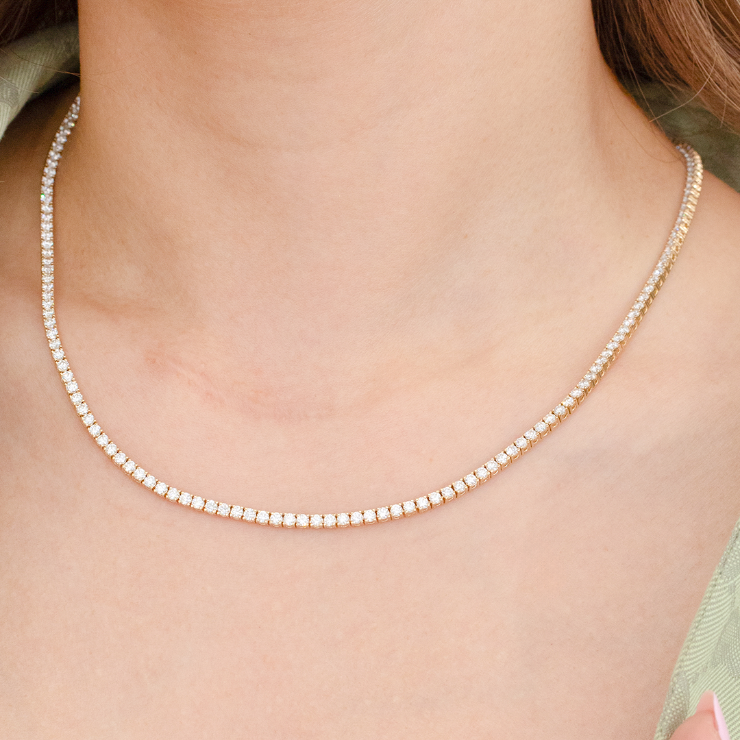 Yellow gold tennis necklace with natural diamonds.