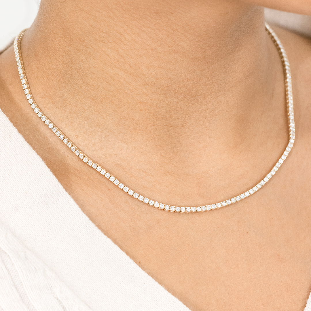 Necklace worn on person, round natural diamonds, tennis setting.