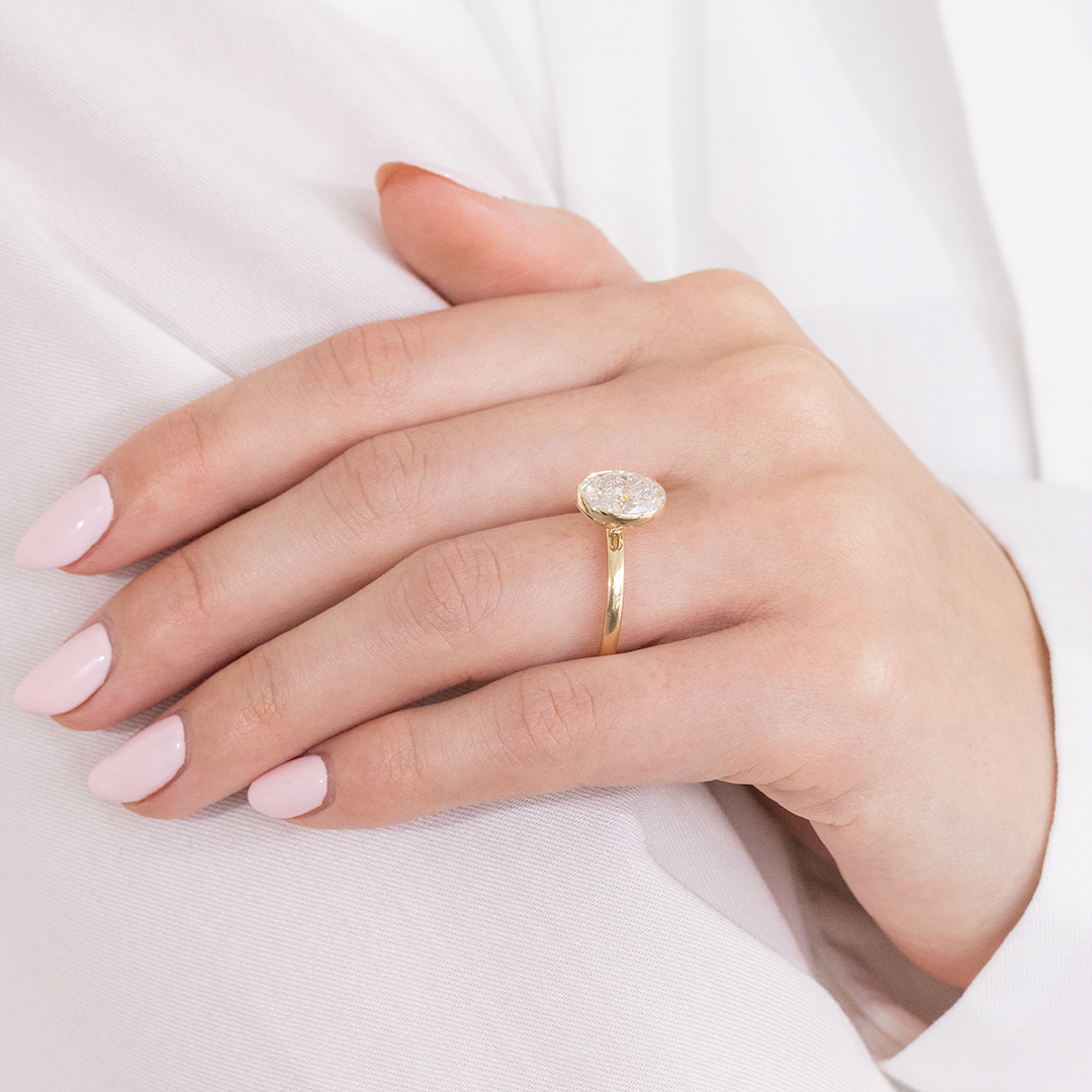 Yellow gold ring video, oval diamond, bezel details, and tulip basket.