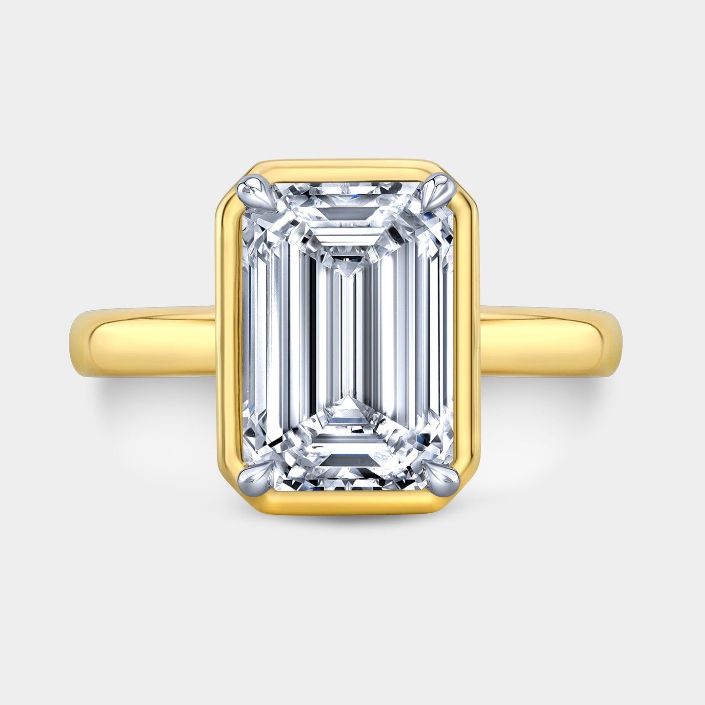 Two tone emerald ring, top view, bezel solitaire.