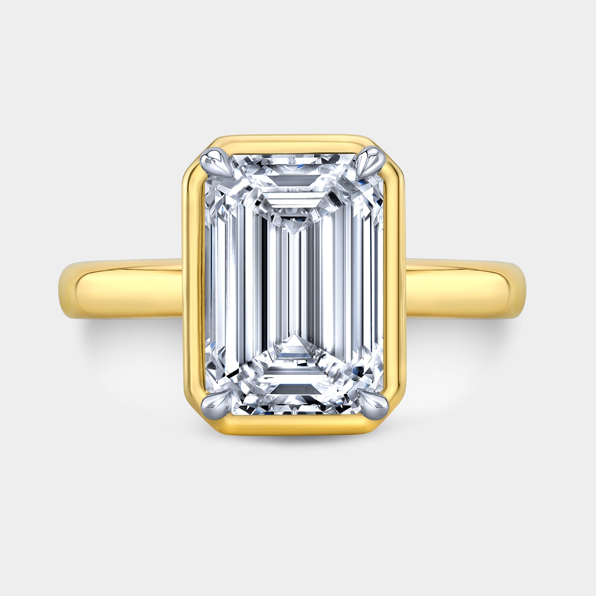 Two tone emerald ring, top view, bezel solitaire.