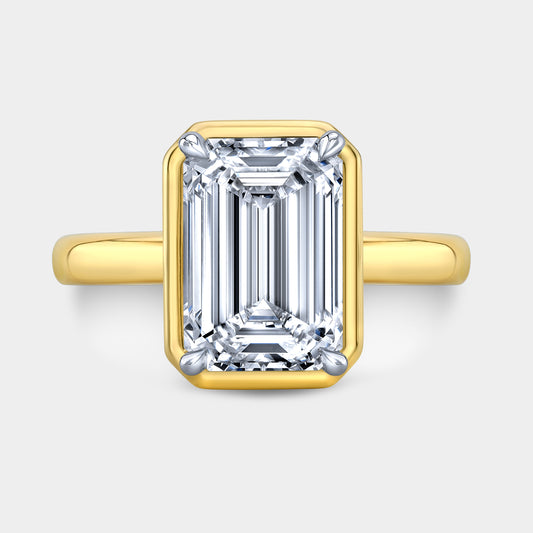Two tone emerald ring, top view, bezel solitaire.