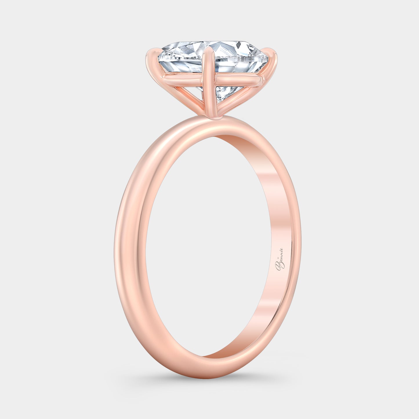 Rose gold diamond ring on hand, pear solitaire.