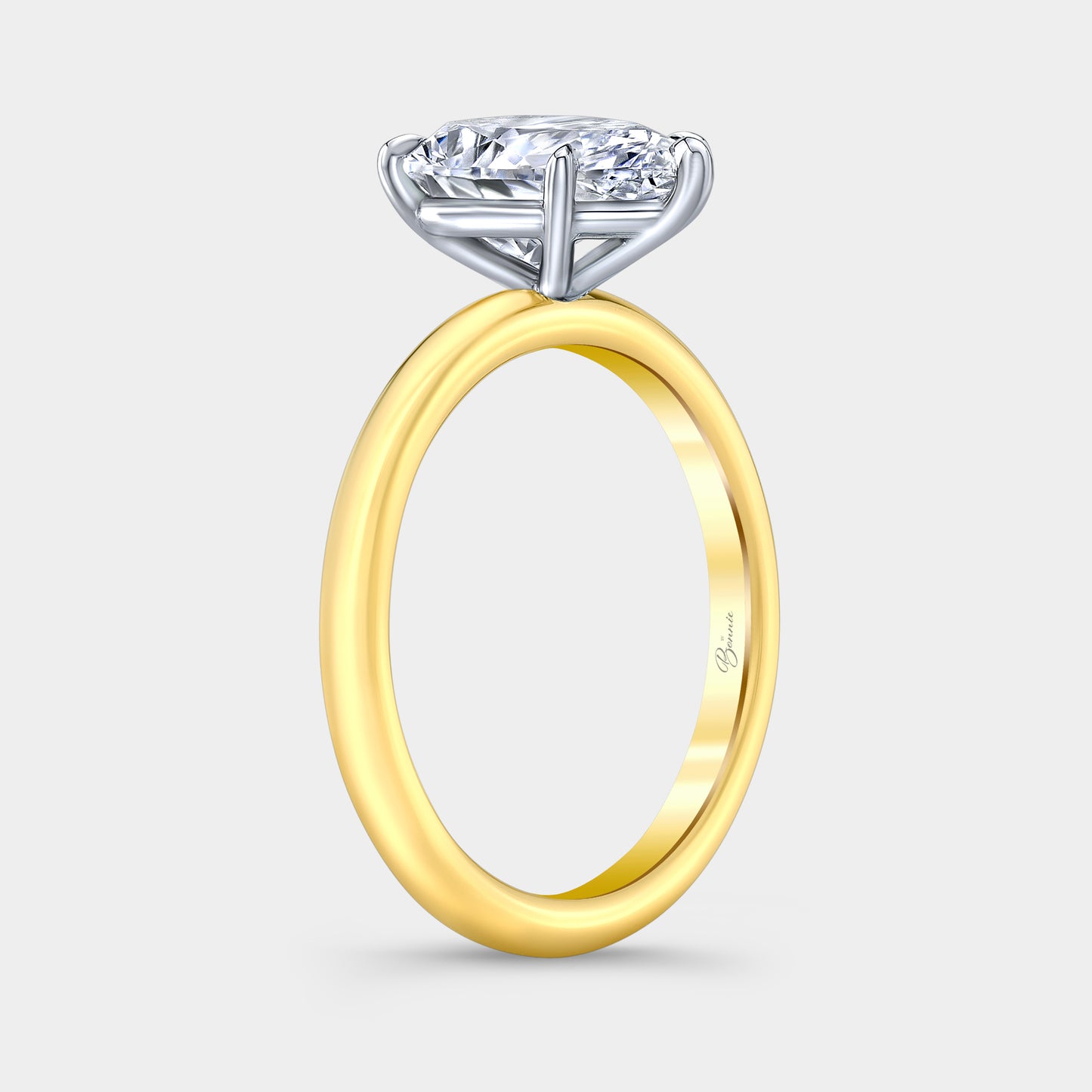 Two tone diamond ring on hand, pear solitaire.