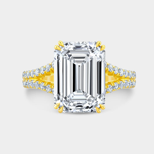 Yellow gold emerald ring, top view, split shank, halo.