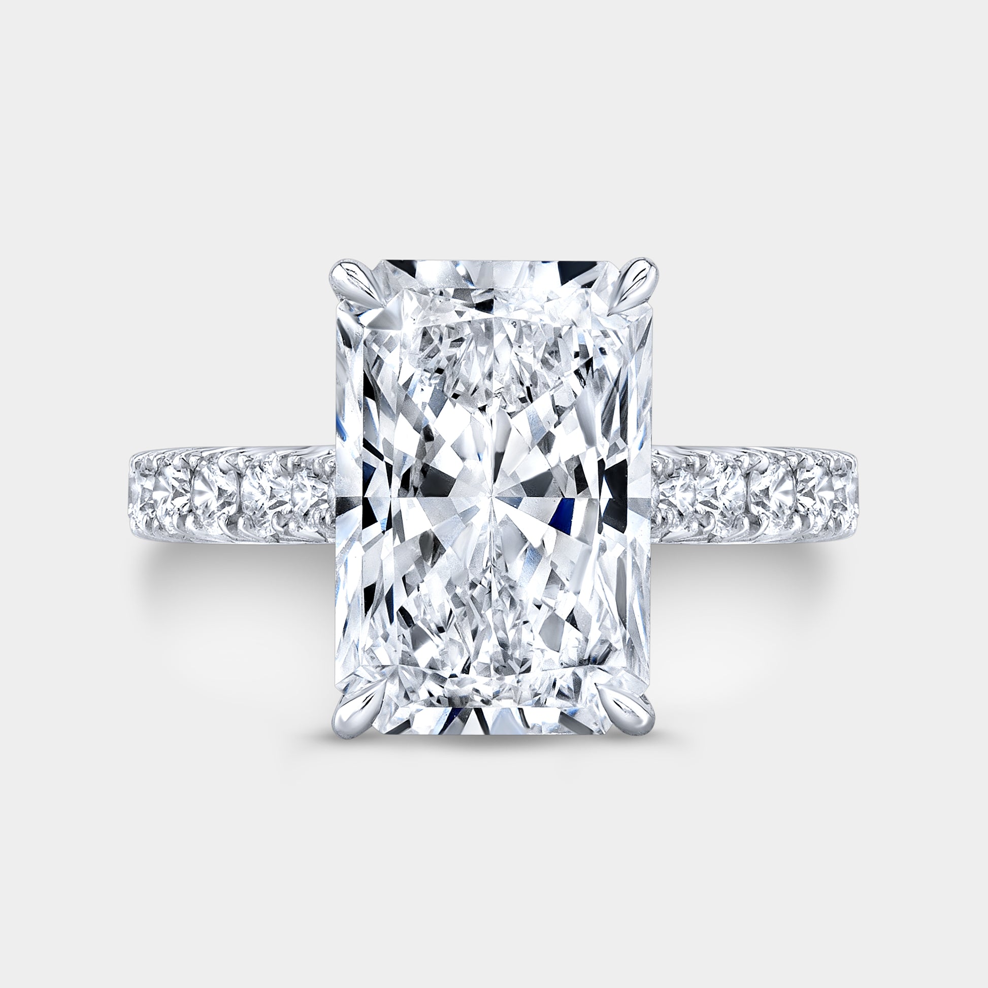 Radiant diamond halo ring, white gold band, French pave.