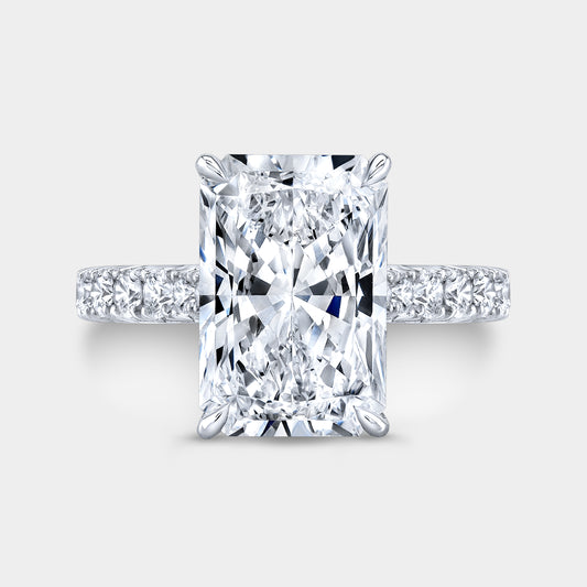 Radiant diamond halo ring, white gold band, French pave.