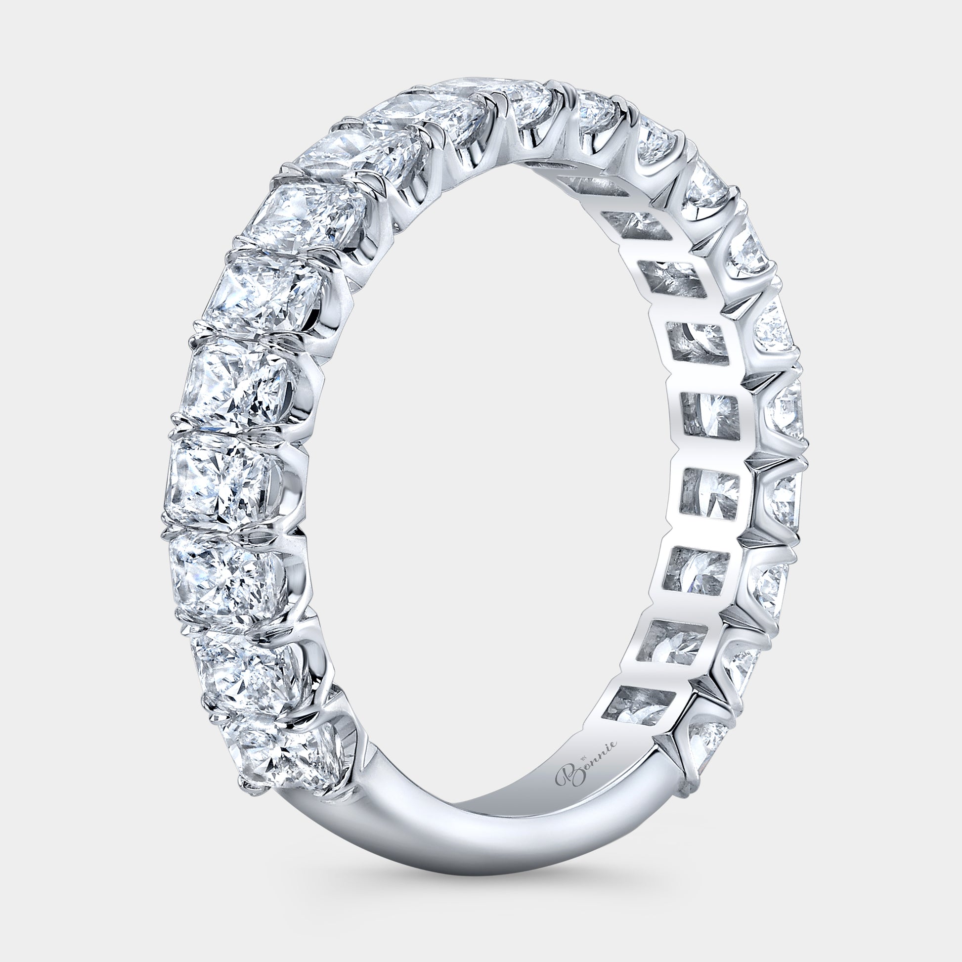 White gold diamond band on hand, radiant cut.