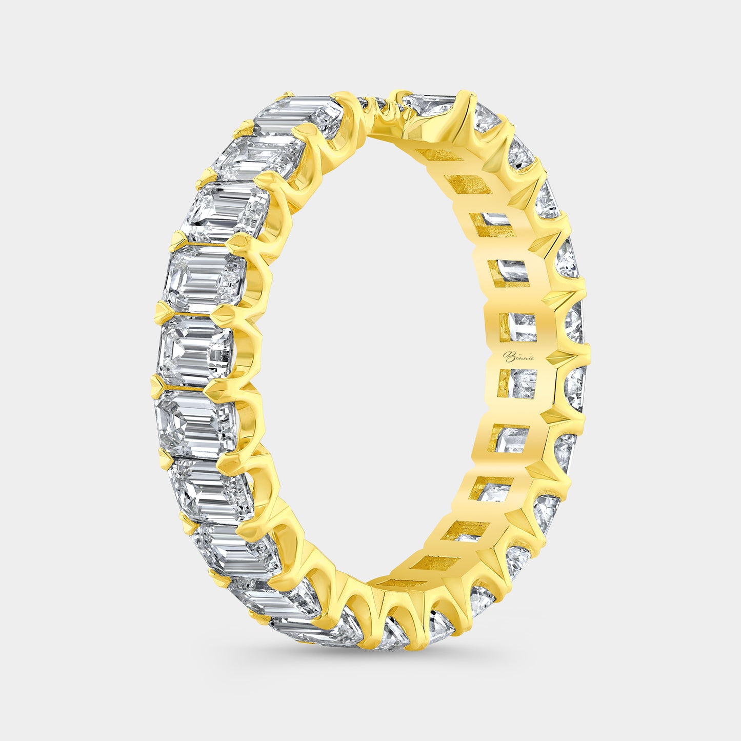 Emerald diamond eternity band, yellow gold setting.