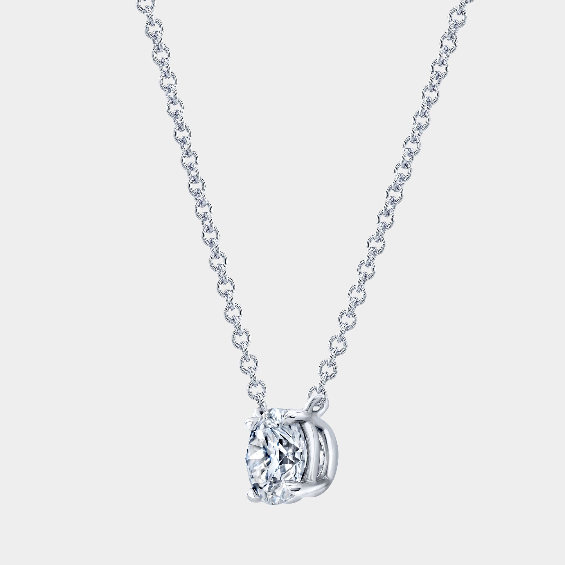 Necklace worn on person, round diamond pendant, 4 prong basket setting.
