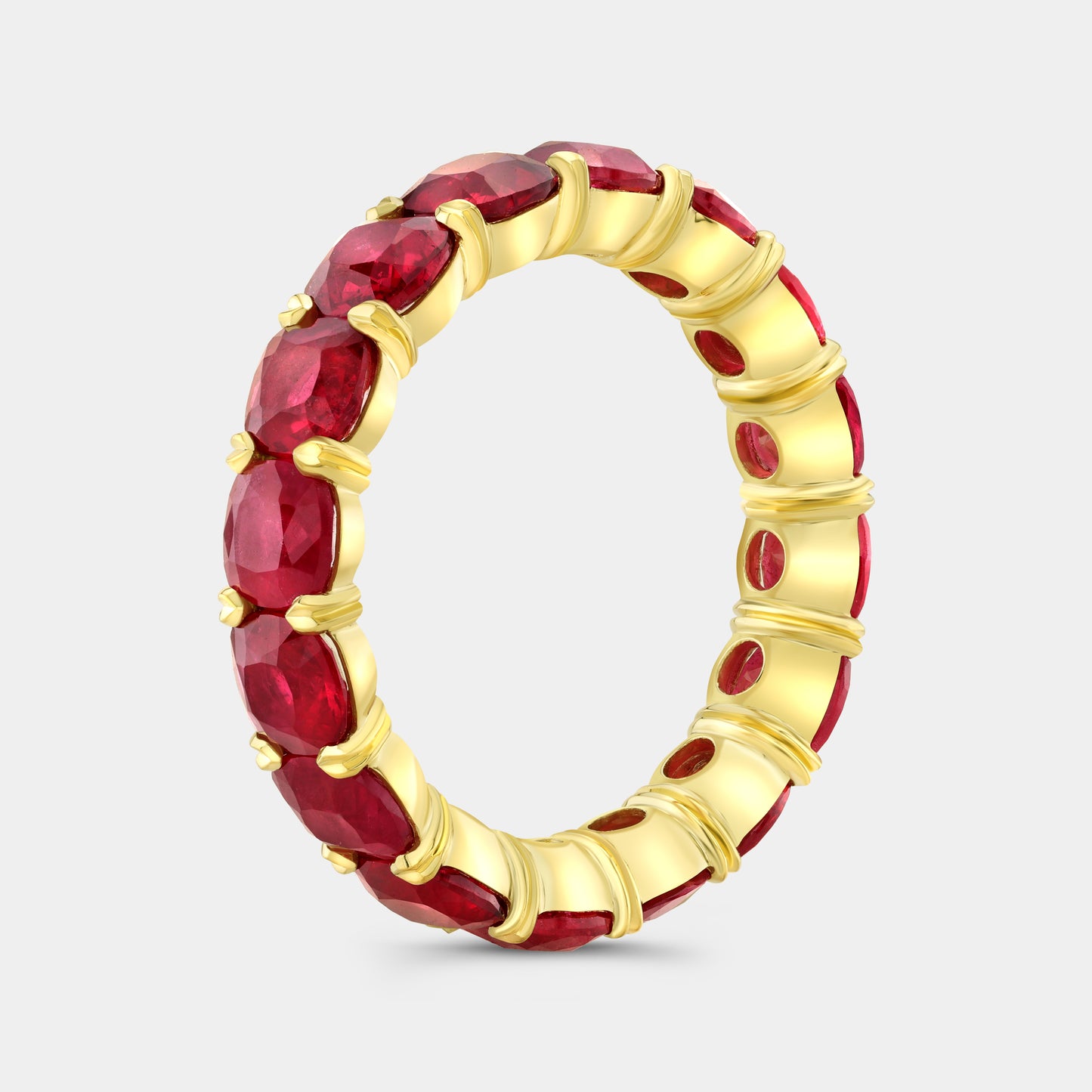 Cushion cut red ruby eternity band, yellow gold setting.