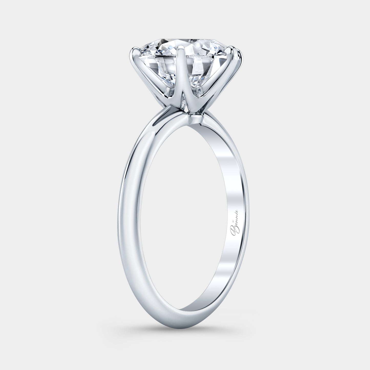 Platinum diamond ring on hand, round solitaire.