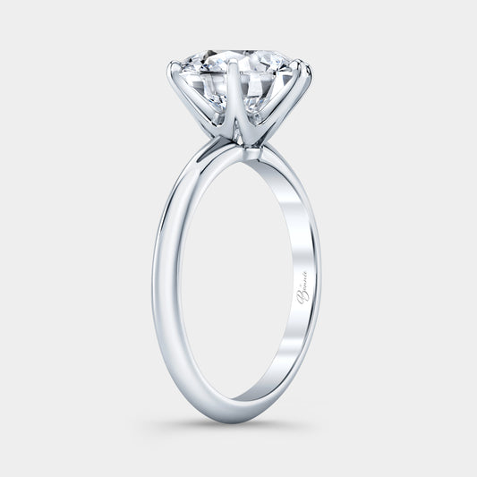 Platinum diamond ring on hand, round solitaire.