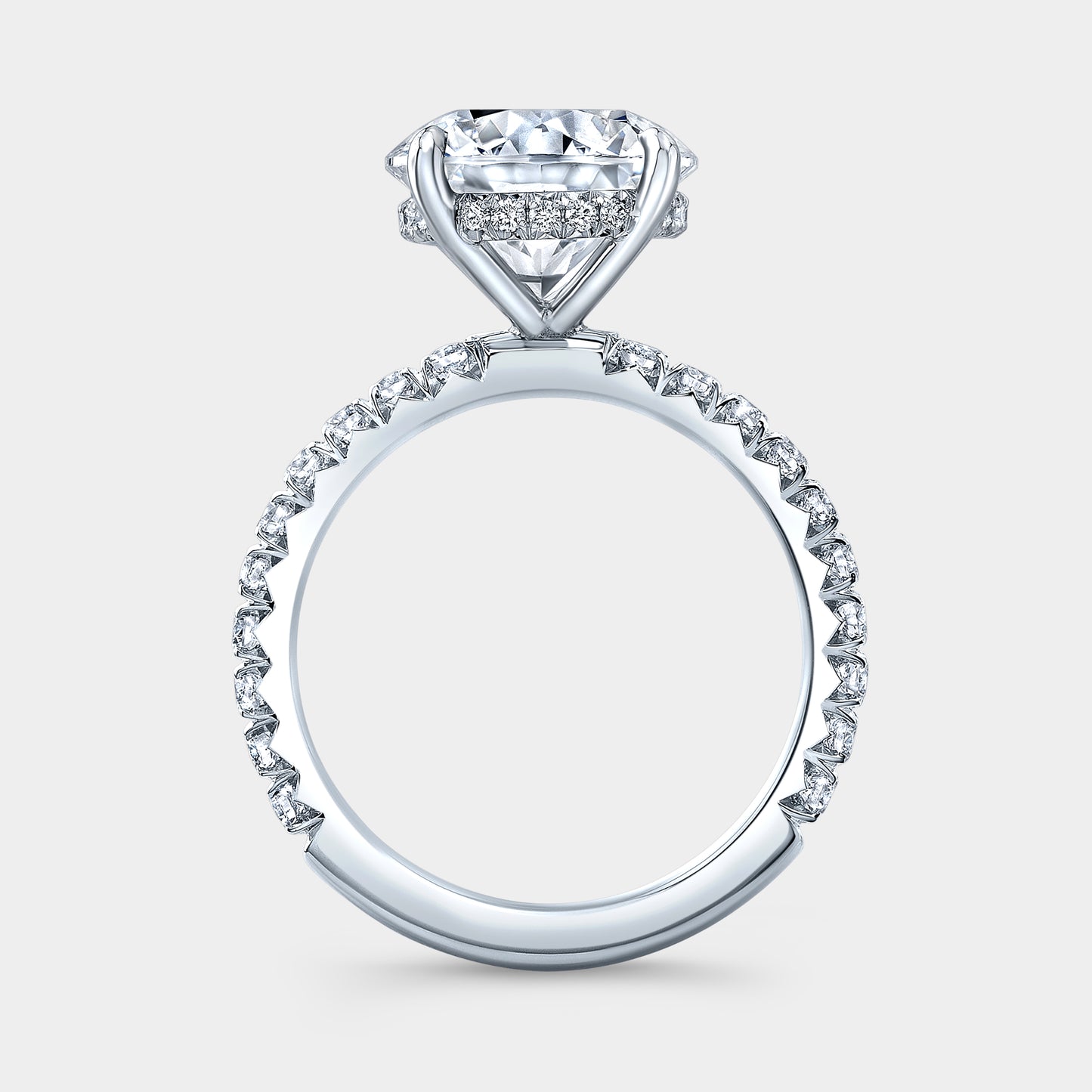 White gold ring, 4 prong setting and pave detail.