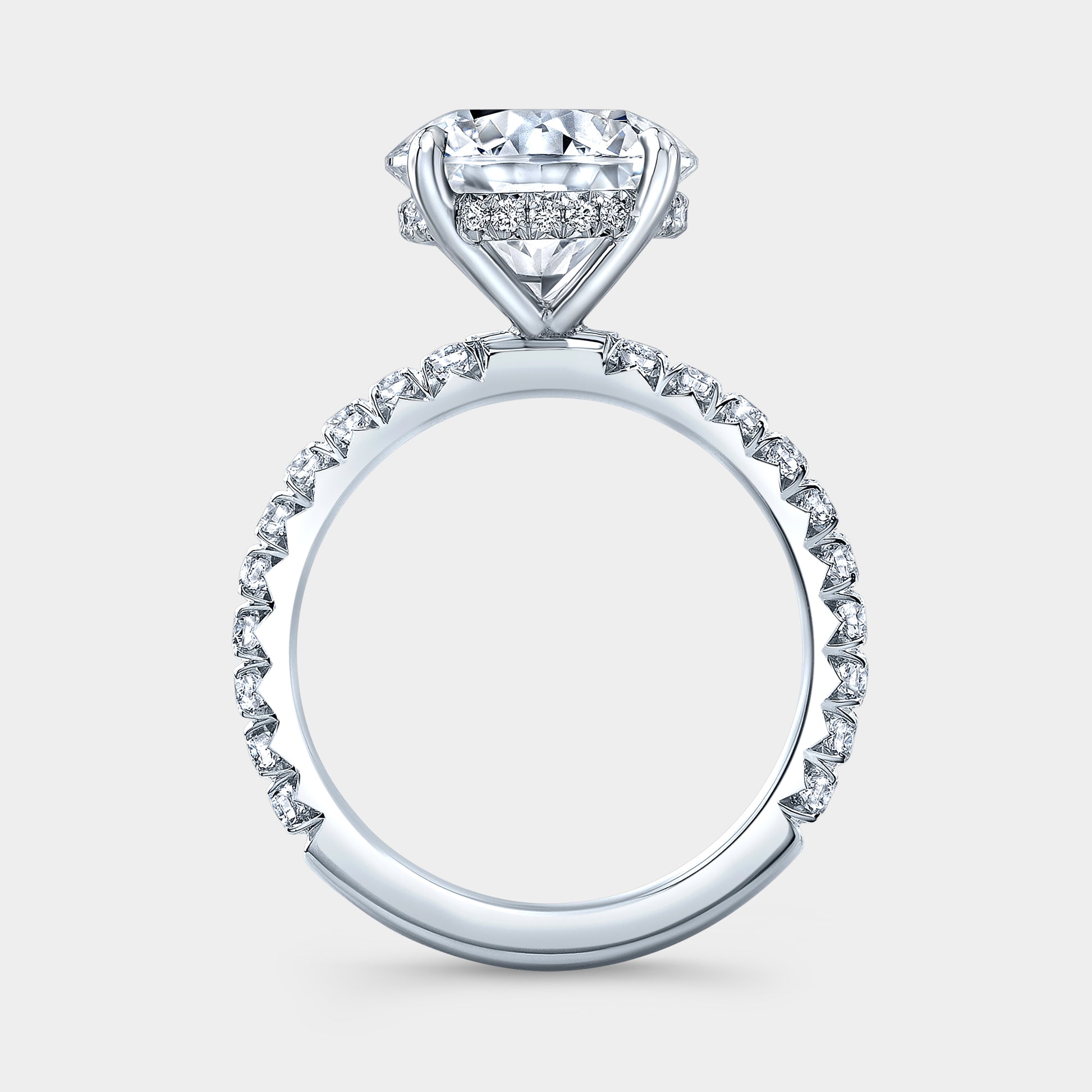 White gold ring, 4 prong setting and pave detail.