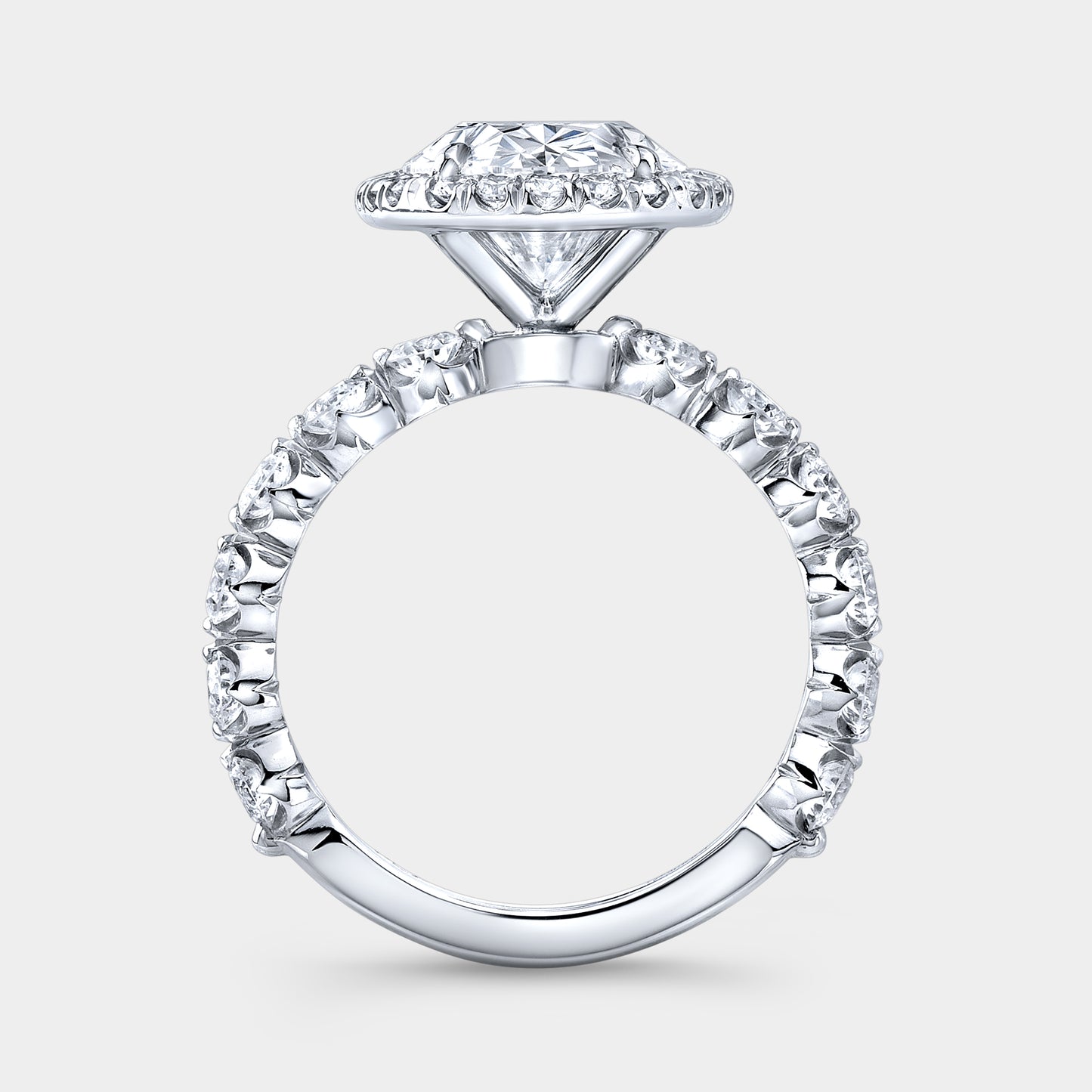 White gold ring, diamond band and halo detail.