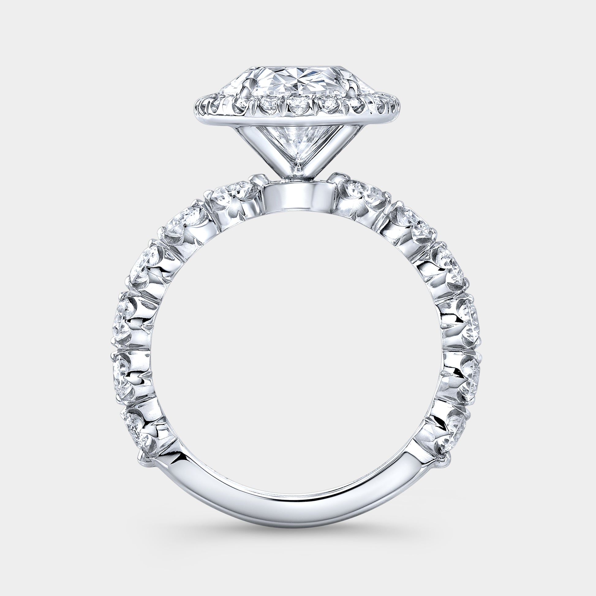 White gold ring, diamond band and halo detail.