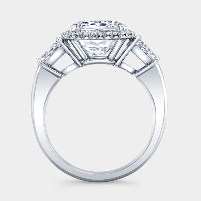 White gold ring, trapezoid side stones and halo detail.