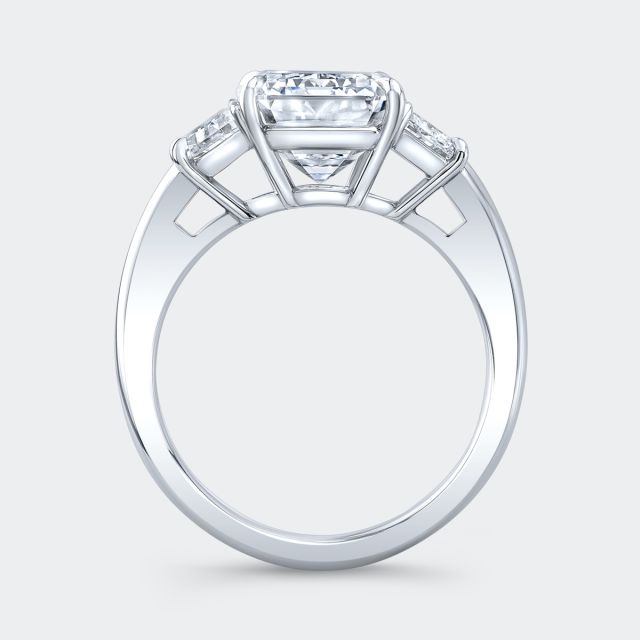 Platinum emerald diamond ring, trapezoid sides, 3 stone.