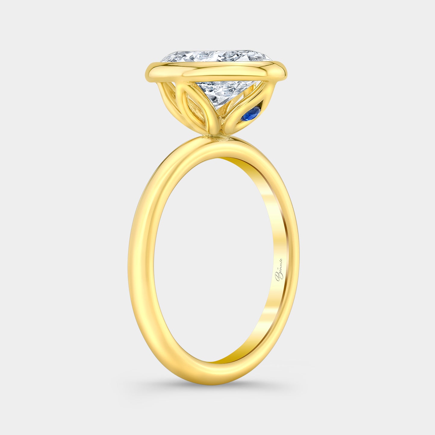Yellow gold diamond ring on hand, oval bezel tulip.